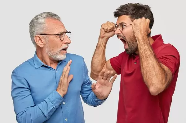 middle aged man yelling at senior man