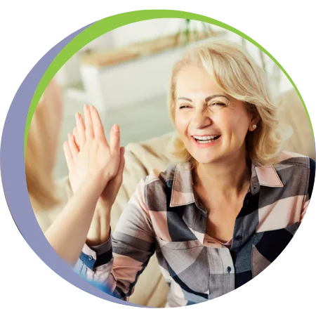 caregiver giving elder woman a high-five