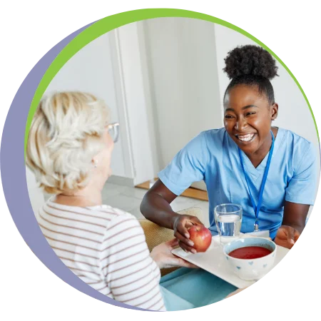home nurse bringing food to senior woman