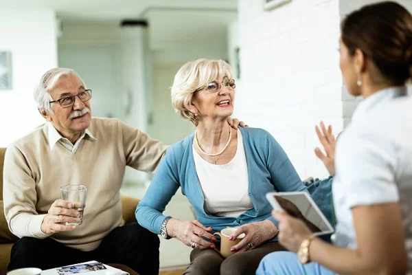 senior couple discussing home care with agent