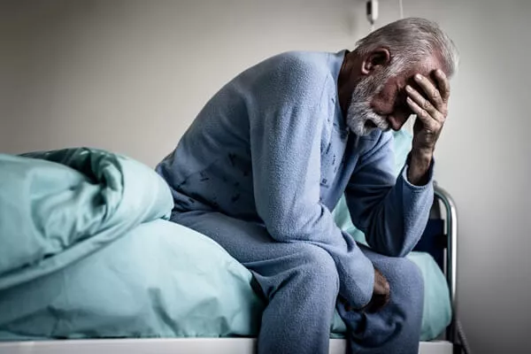 senior man exhausted and unable to sleep