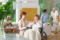 senior and caregiver in assisted living facility