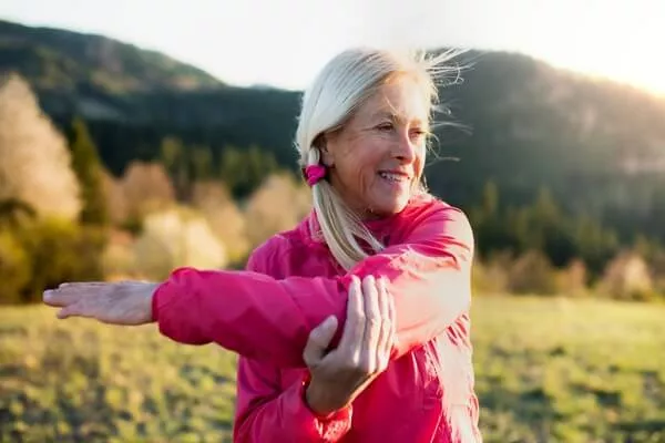 Senior woman stretching outdoors