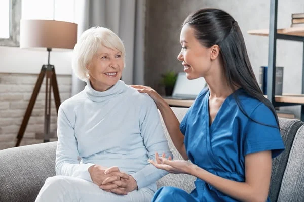 senior and caregiver women smiling