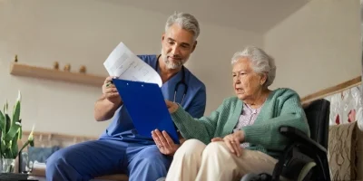 caregiver serving elderly woman coffee
