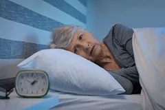 Senior woman lying awake restlessly